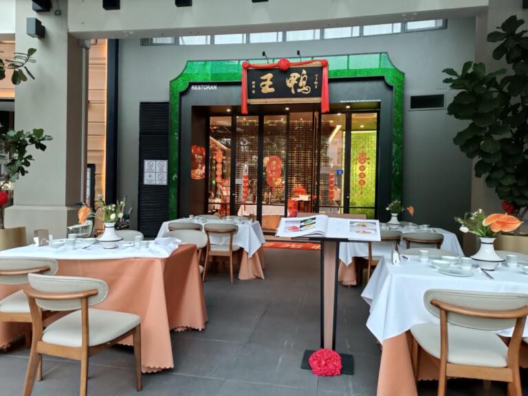 Outdoor dining area of a Chinese restaurant with set tables.