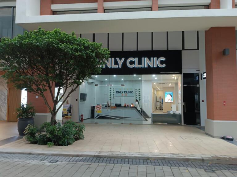ONLY CLINIC entrance with a small tree and glass facade.