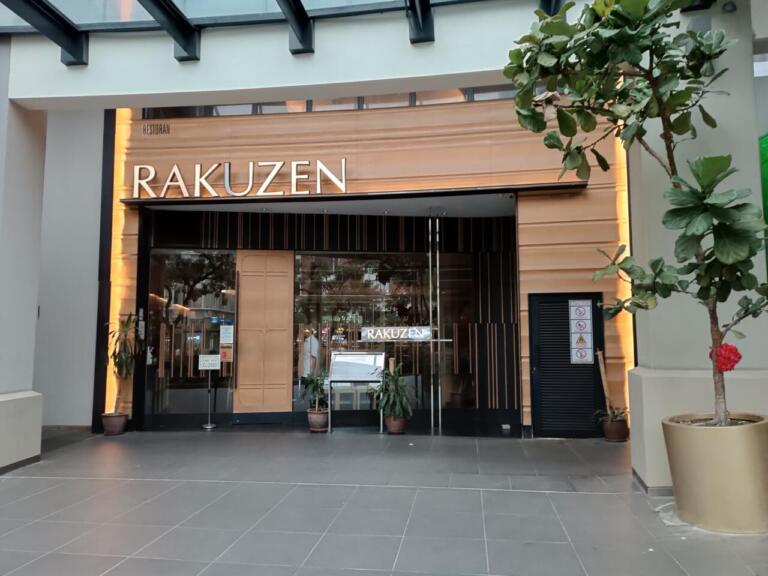 Rakuzen restaurant exterior with wooden facade and glass entrance.